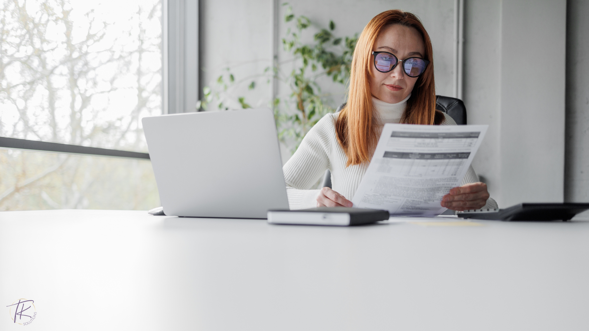 Female ntrepreneur reviewing financial reports to future-proof business finances.