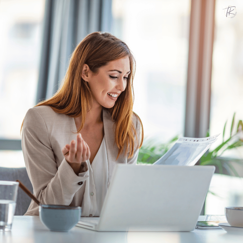 Female founder reviewing financial dashboards and data with excitement representing business clarity