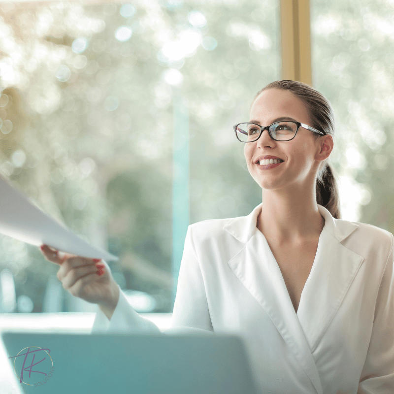 A woman founder hands off a commission report after reviewing team commission data to assess profitability