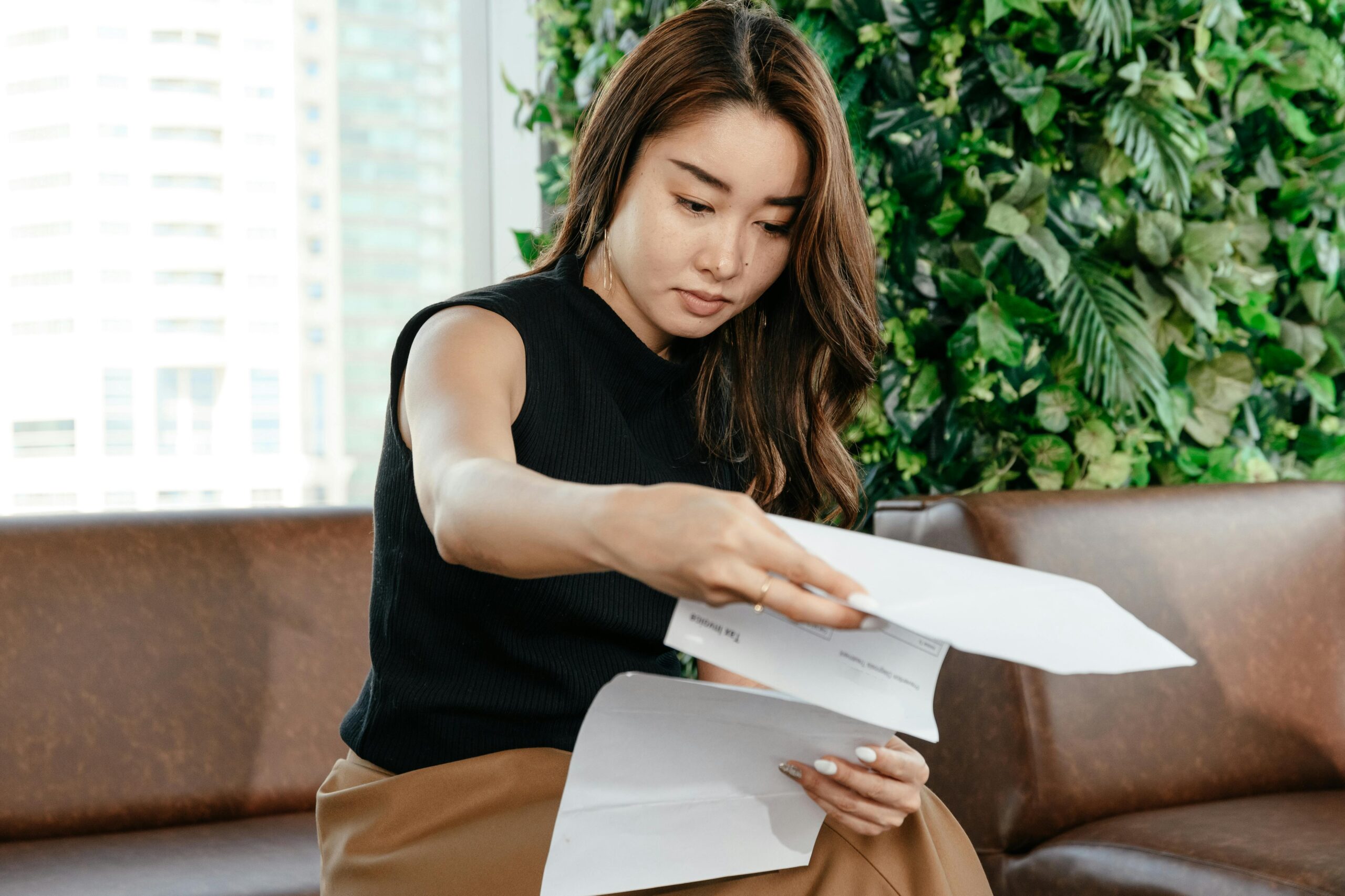 Business owner reviewing financial documents in a modern office setting, representing the transition from early financial complexity to fundable growth
