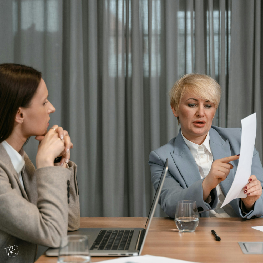 Business leaders reviewing a document together, reflecting decision-making shifting from founder to team